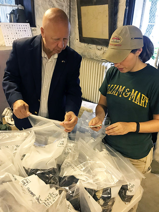 State Sen. Mario Scavello and Haley Hoffman look over some bagged artifacts.